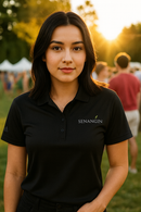 Woman wearing a black polo shirt with 'SENANGIN' logo in an outdoor setting